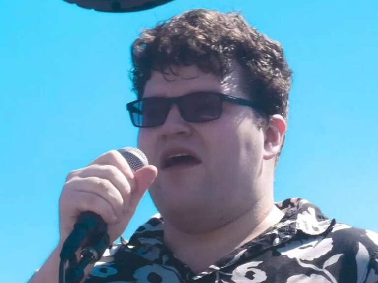 The vocalist Marty singing with a microphone